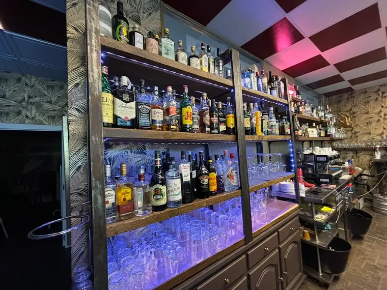 Backlit spirits shelves above the bar in Estepona