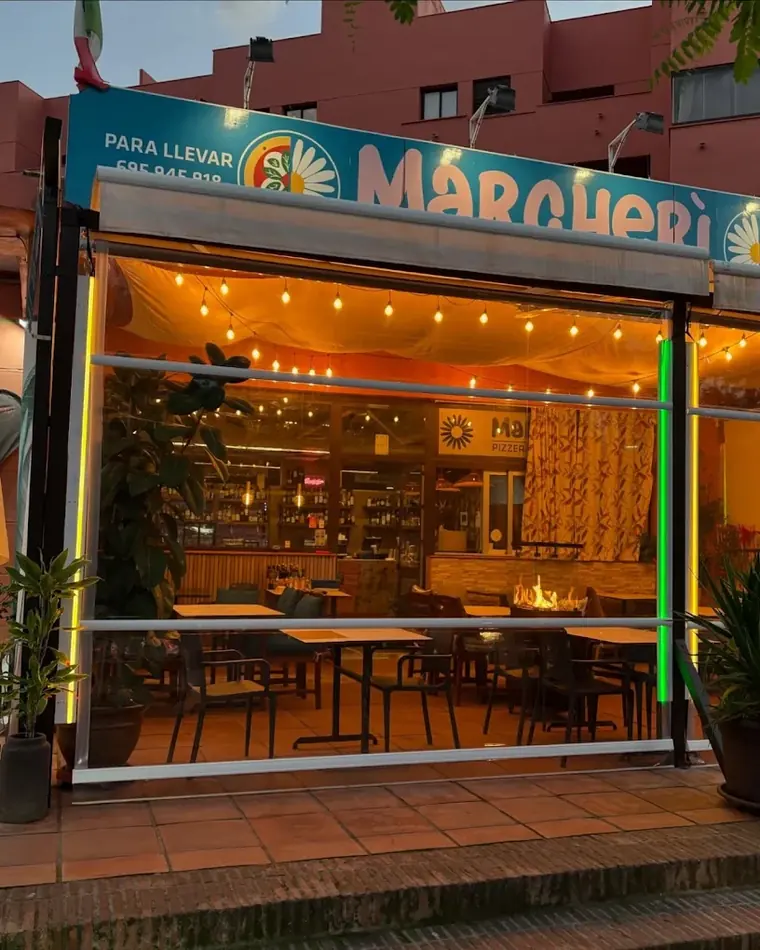 The Margher&igrave; shopfront in Estepona lit up at dusk