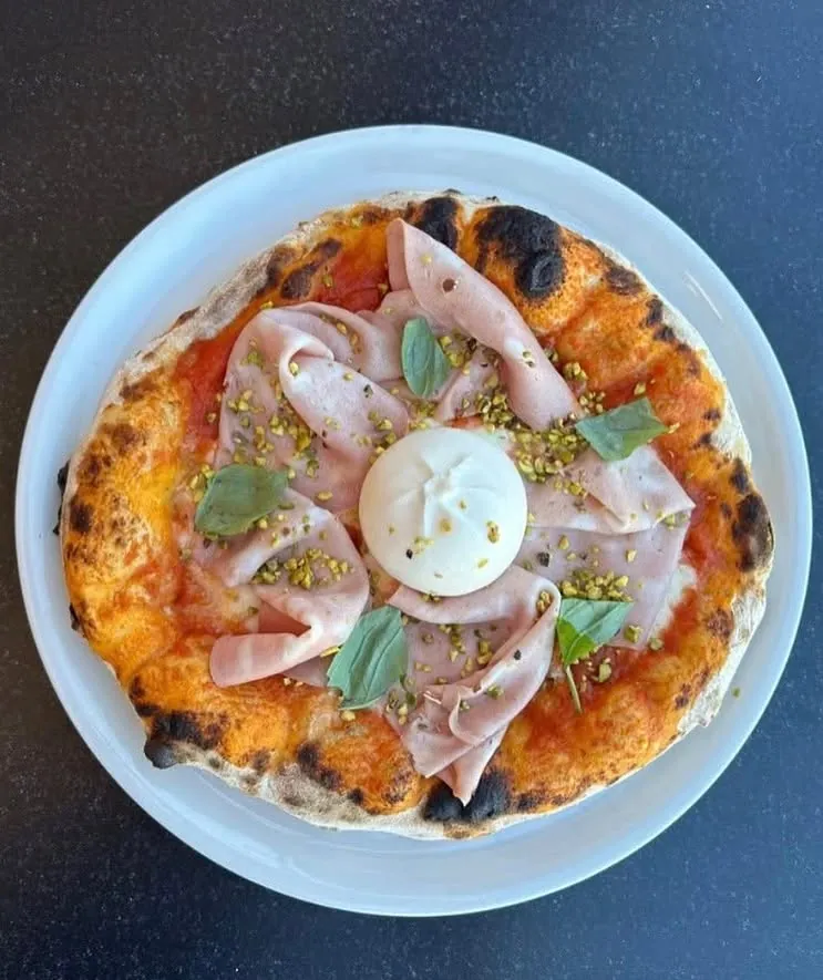 Pizza with mortadella, burrata and pistachio