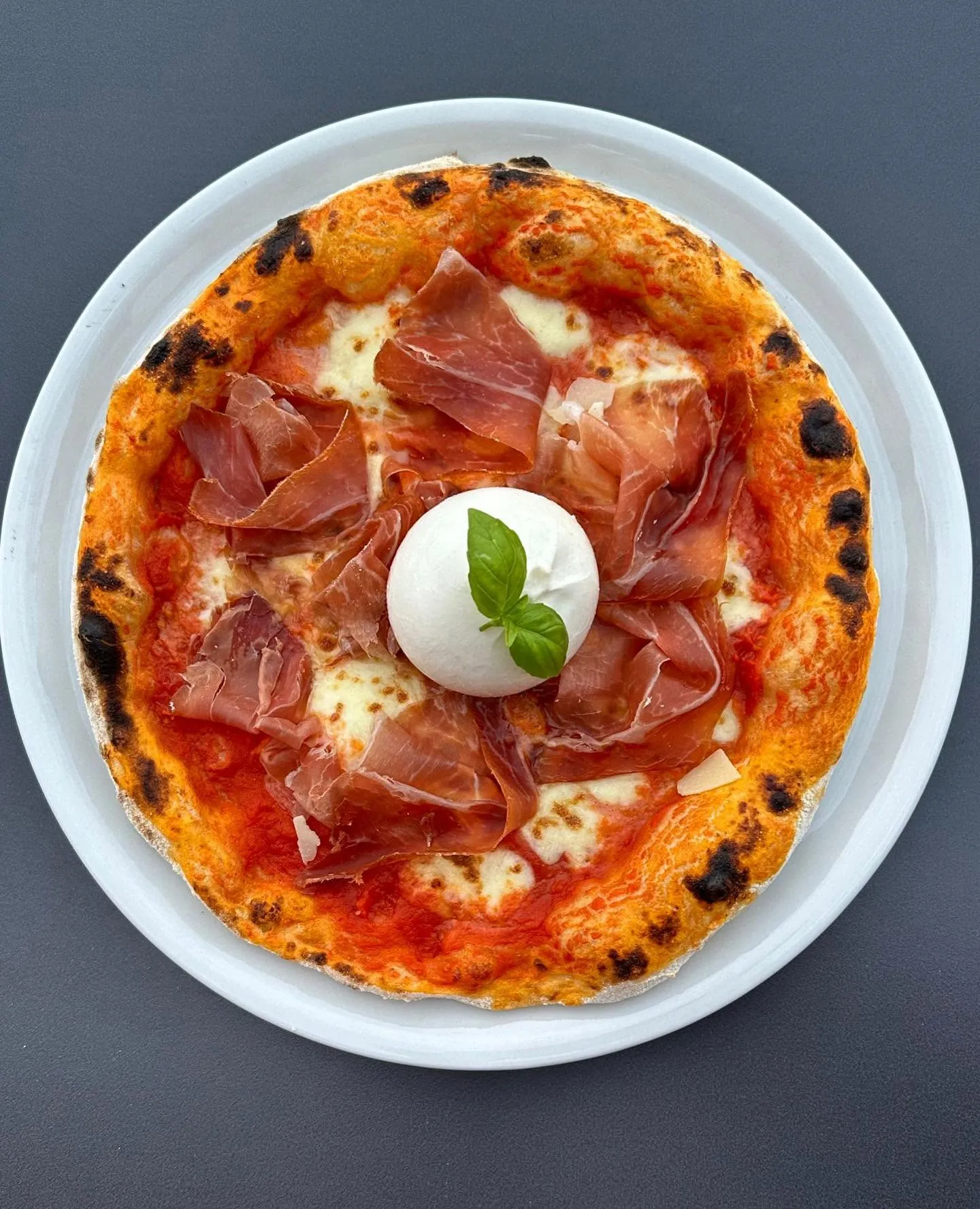 Pizza with Parma ham, burrata and basil