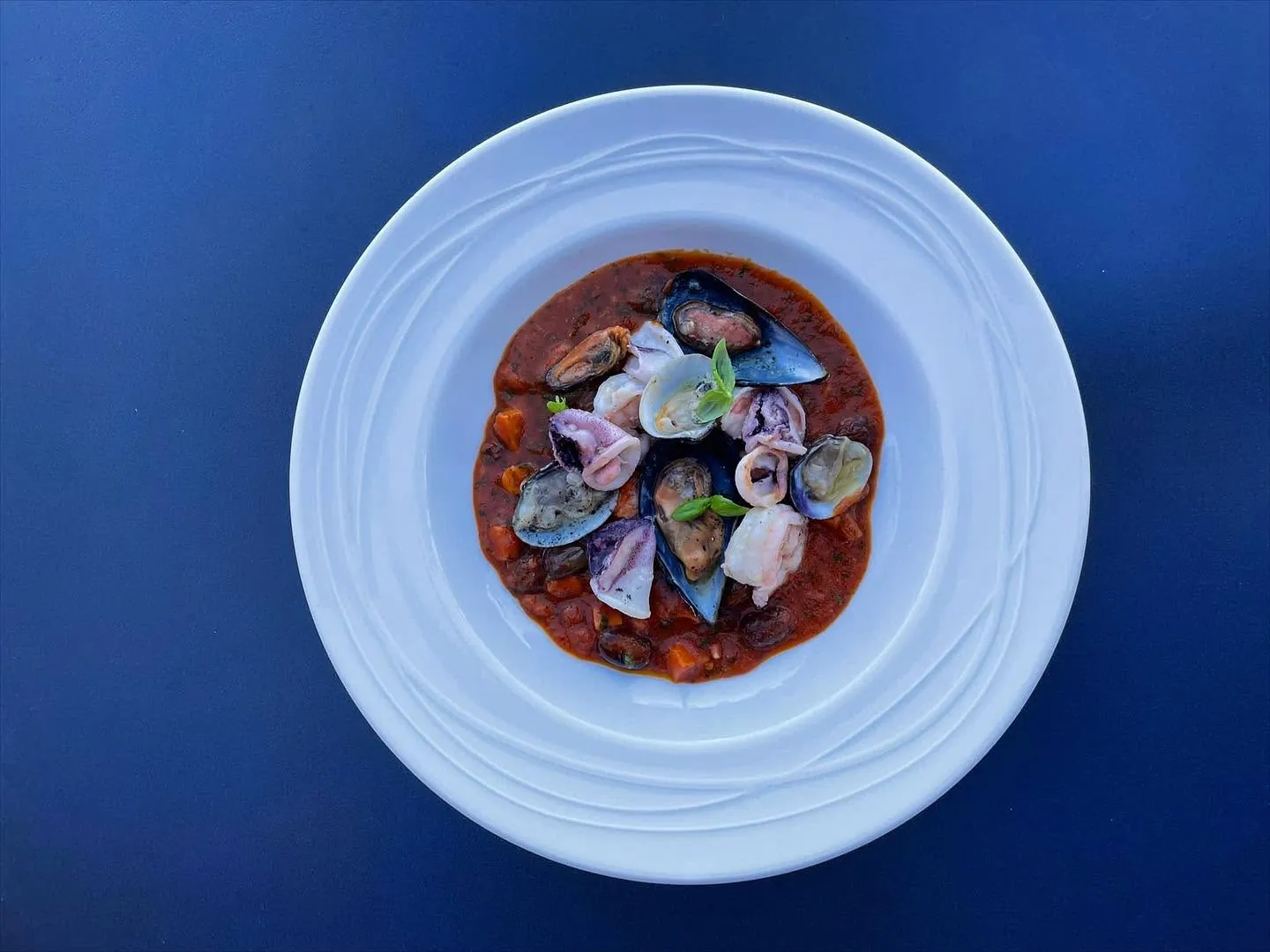 Beef tartare plated on a blue table