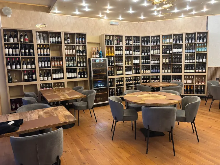 Tables set among the wine shelves at Sotogrande